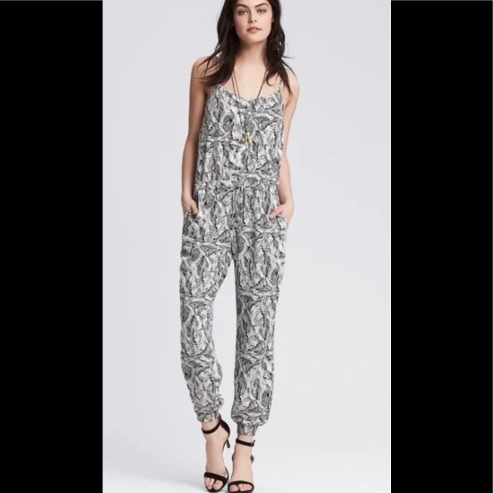 Black and white print jumpsuit with adjustable spaghetti straps.